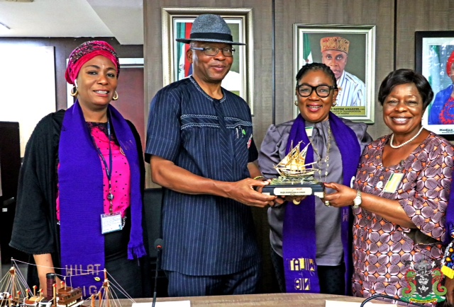 The Representative of the Managing Director NPA, the Executive Director Marine and Operations Dr Sokonte Huttin Davies standing second left,receives a memorabilia from the Chairperson WILAT Folake Soji- George with a helping hand from the Iyalode of Egbaland Chief Mrs. Alaba Lawson matron WILAT, to his right is Khadijat Sheidu- Shabi Vice Chairperson WILAT & Assistant General Manager Environment NPA.