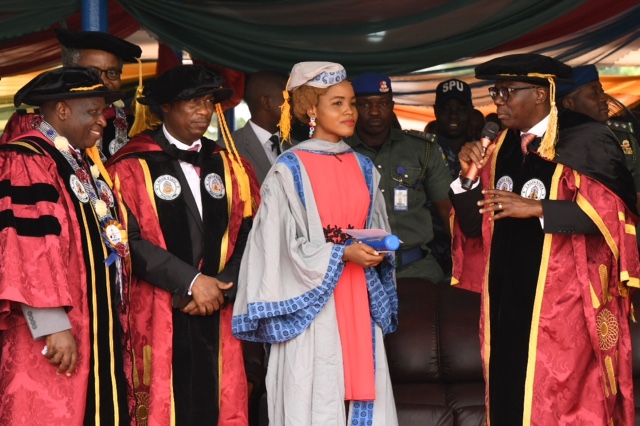Lagos State Governor, Mr. Babajide Sanwo-Olu (second right), presenting a certificate to the Overall Best Graduating Student, Miss Nkechi Alexandra Kingsley (second left), while the Deputy Governor, Dr. Obafemi Hamzat (middle); Rector, Lagos State Polytechnic, Mr. Samuel Sogunro (left) and Special Adviser to the Governor on Education, Mr. Tokunbo Wahab (right), watch with admiration, during the 27th Convocation and Award Ceremony of Lagos State Polytechnic at the Convocation Ground, Ikorodu Campus, Lagos, on Thursday, March 12, 2020.