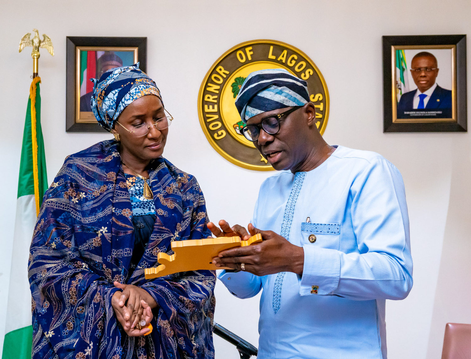 Minister of Humanitarian Affairs, Disaster Management and Social Development, Hajiya Sadiya Umar Farouq (left) being presented with a plaque by Lagos State Governor, Mr. Babajide Sanwo-Olu during a commiseration visit over the recent Abule-AdoSoba explosions at Lagos House, Marina, on Wednesday, March 18, 2020.