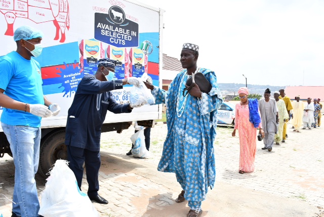 > A & B: National Sales Manager, Natnudo Foods, Mr Yomi Gbadamosi (left); President General, Central Council of Ibadan Indigenes, Chief Yemi Soladoye (second left) presenting frozen chickens to people of Ibadan as Covid-19 relief to 500 peoples by Natnudo Foods Limited held at Ibadan House.