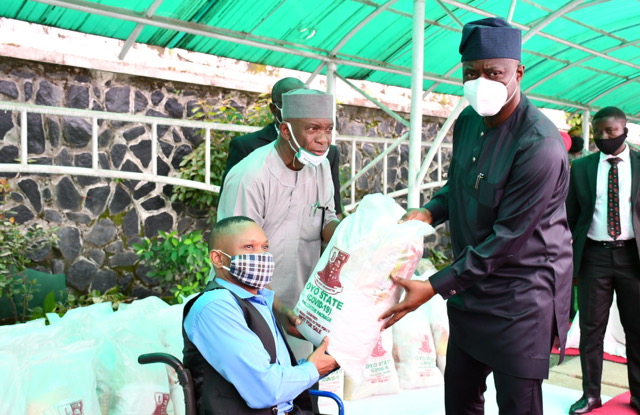 Oyo State Governor, Engr Seyi Makinde (right); being assisted by Commissioner for Special Duties, Chief Bayo Lawal (middle) presenting palliative material to Mr Olusola Ogundola during the symbolic distribution of Palliatives to People living with disabilities held at Governor's Office, Ibadan. PHOTO: Oyo State Government.